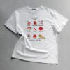 Weißes T-Shirt mit einer Illustration von Nähutensilien und dem Schriftzug Sew Obsessed, präsentiert auf einem grauen Untergrund von Anke.